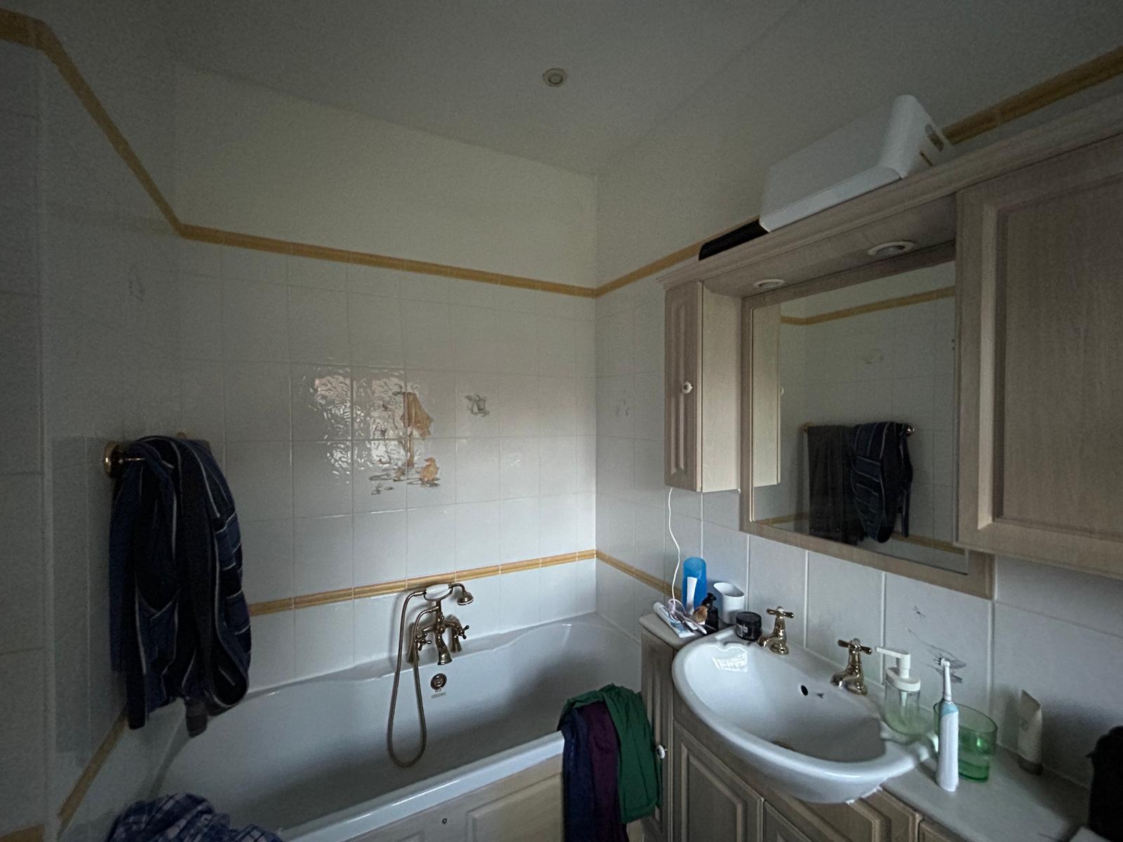 Before — a dated cream-and-oak bathroom, the starting point for one of the refits shown above.